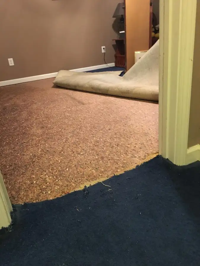 Carpet pad removal revealing water damage during Water Mitigation Services in Sulphur